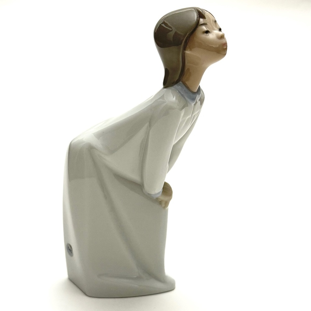 Lladro "Girl Kissing" porcelain figurine, #4873. First issued 1973, retired 1999